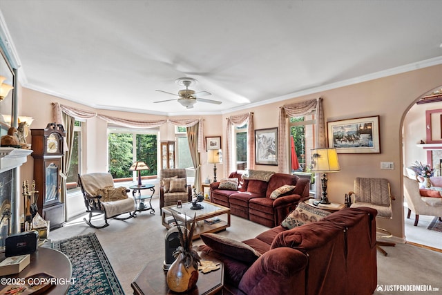 2215 S Austin Cir, Palmer, AK 99645 - carpeted living room with arched walkways, a high end fireplace, crown molding, and a ceiling fan