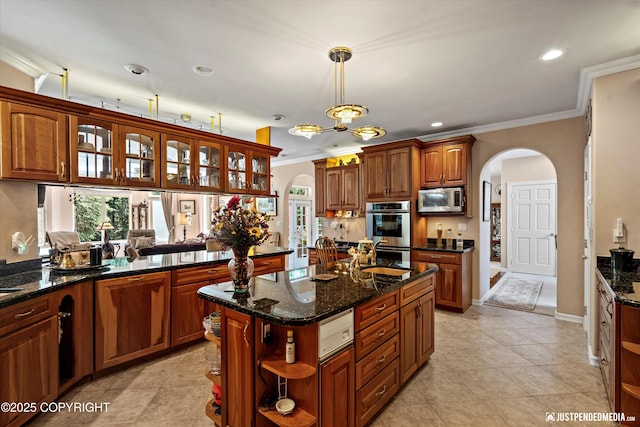 2215 S Austin Cir, Palmer, AK 99645 - kitchen with arched walkways, appliances with stainless steel finishes, open shelves, crown molding, and decorative light fixtures
