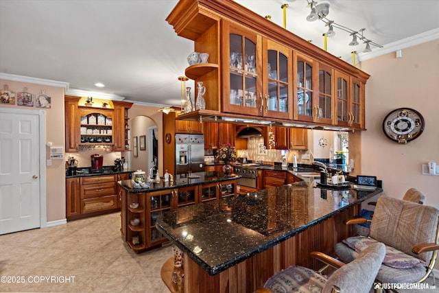 2215 S Austin Cir, Palmer, AK 99645 - kitchen with open shelves, ornamental molding, appliances with stainless steel finishes, arched walkways, and a kitchen breakfast bar