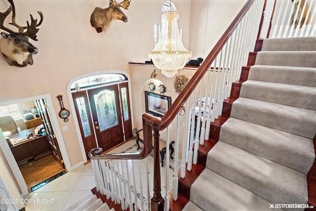 2215 S Austin Cir, Palmer, AK 99645 - tiled entrance foyer featuring a chandelier, healthy amount of natural light, stairway, and a towering ceiling