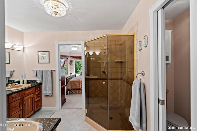 2215 S Austin Cir, Palmer, AK 99645 - bathroom with vanity, tile patterned flooring, a shower stall, and ensuite bath