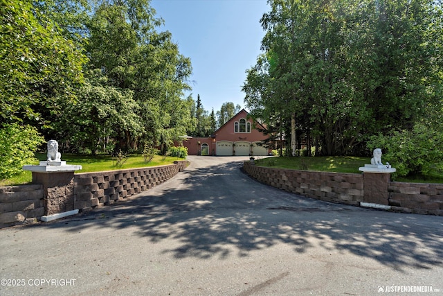 2215 S Austin Cir, Palmer, AK 99645 - view of front of house with asphalt driveway, a garage, and a front yard