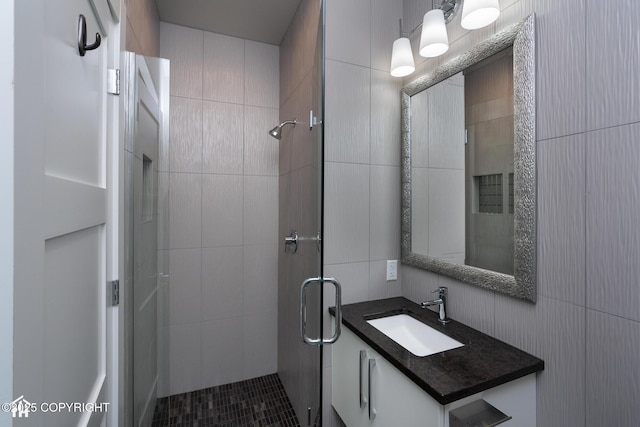 528 Coastal Pl # 1, Anchorage, AK 99501 - full bath featuring a stall shower, vanity, and tile walls