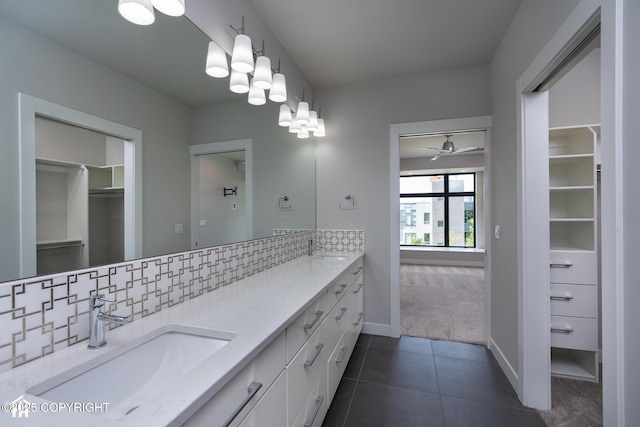 528 Coastal Pl # 1, Anchorage, AK 99501 - full bath featuring double vanity, a walk in closet, ceiling fan, tasteful backsplash, and tile patterned flooring