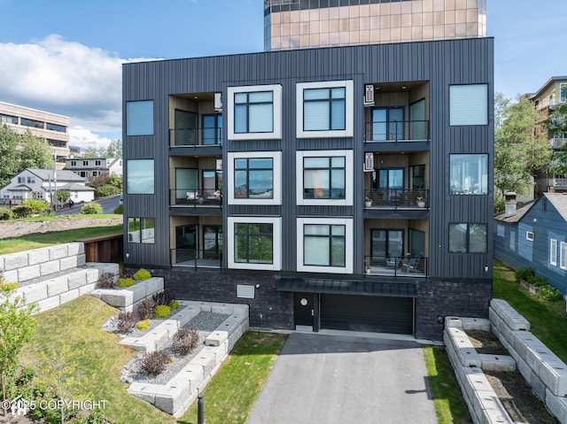 528 Coastal Pl # 1, Anchorage, AK 99501 - view of property with an attached garage and driveway