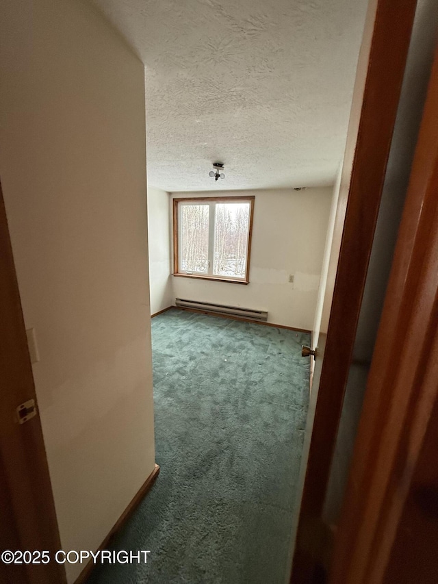 9810 N Runyon Cir, Palmer, AK 99645 - unfurnished room with carpet flooring, a baseboard heating unit, and a textured ceiling
