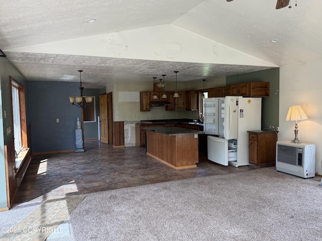 9810 N Runyon Cir, Palmer, AK 99645 - kitchen featuring freestanding refrigerator, a kitchen island, open floor plan, a chandelier, and lofted ceiling