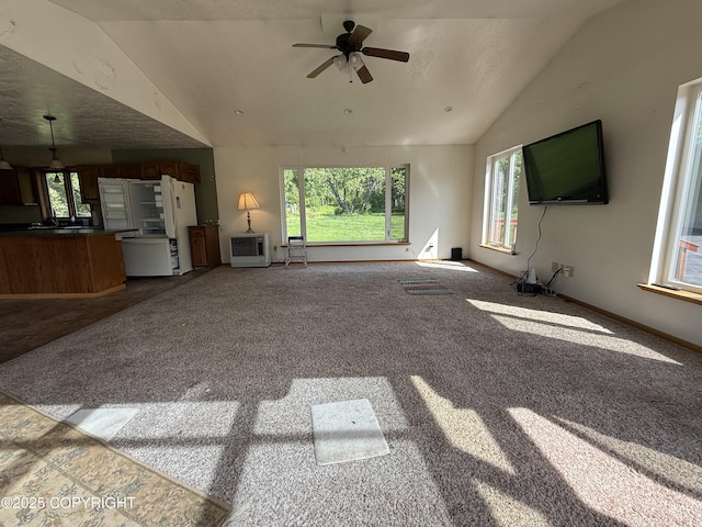 9810 N Runyon Cir, Palmer, AK 99645 - unfurnished living room with lofted ceiling, healthy amount of natural light, carpet flooring, and a ceiling fan