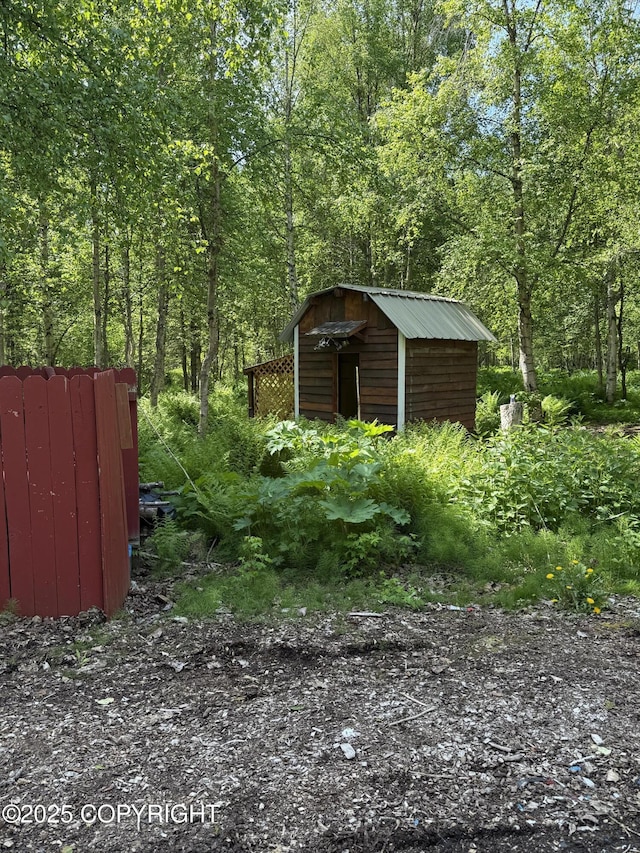 9810 N Runyon Cir, Palmer, AK 99645 - view of yard with a storage shed and a forest view