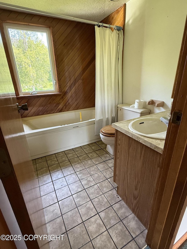 9810 N Runyon Cir, Palmer, AK 99645 - full bathroom featuring tile patterned flooring, vanity, shower / tub combo with curtain, and a textured ceiling