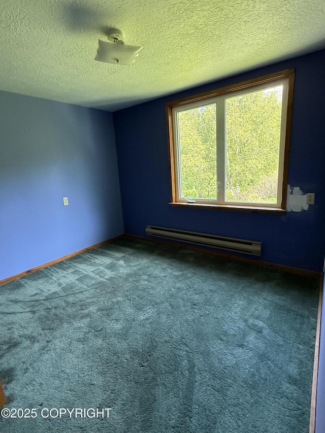 9810 N Runyon Cir, Palmer, AK 99645 - carpeted empty room featuring a baseboard radiator and a textured ceiling