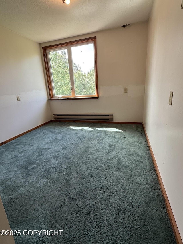 9810 N Runyon Cir, Palmer, AK 99645 - unfurnished room featuring baseboard heating, carpet floors, and a textured ceiling