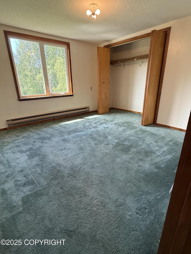 9810 N Runyon Cir, Palmer, AK 99645 - unfurnished bedroom featuring a baseboard heating unit, multiple windows, a textured ceiling, carpet, and a closet