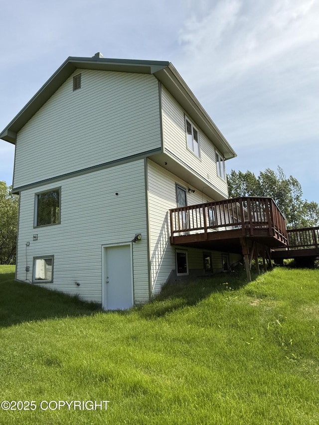 9810 N Runyon Cir, Palmer, AK 99645 - back of house featuring a wooden deck and a yard