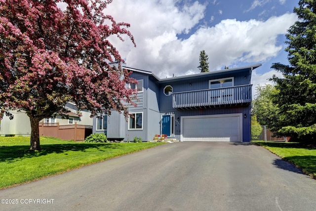 6831 Cheryl St, Anchorage, AK 99518 - view of front of property featuring a balcony, asphalt driveway, and an attached garage