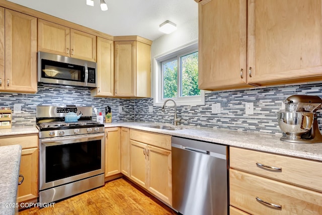 6831 Cheryl St, Anchorage, AK 99518 - kitchen with appliances with stainless steel finishes, light brown cabinets, and a sink