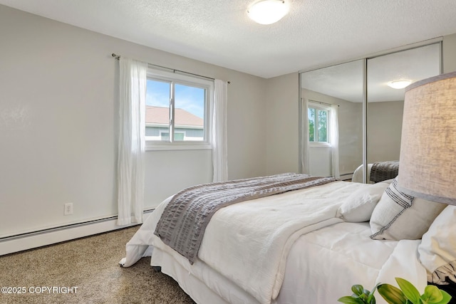6831 Cheryl St, Anchorage, AK 99518 - carpeted bedroom with a textured ceiling, a closet, a baseboard heating unit, and baseboards