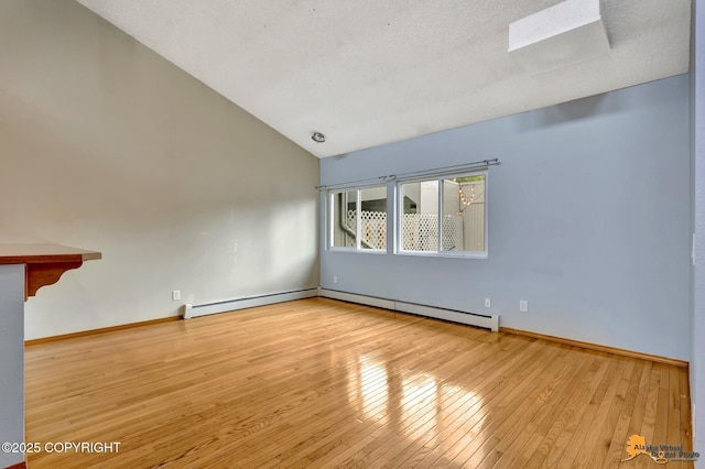 3135 Delta Dr, Anchorage, AK 99502 - empty room featuring vaulted ceiling, hardwood / wood-style flooring, baseboards, and baseboard heating