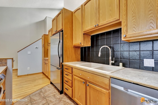3135 Delta Dr, Anchorage, AK 99502 - kitchen featuring stainless steel appliances, a sink, light countertops, and decorative backsplash