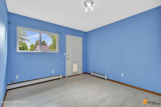 3135 Delta Dr, Anchorage, AK 99502 - unfurnished room with baseboard heating, wood finished floors, and baseboards