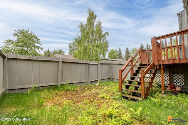 3135 Delta Dr, Anchorage, AK 99502 - fenced backyard with a wooden deck and stairway