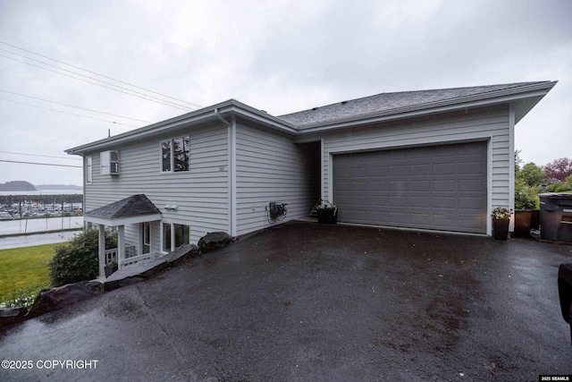 101 Jeff Davis St, Sitka, AK 99835 - view of front facade featuring asphalt driveway and a garage