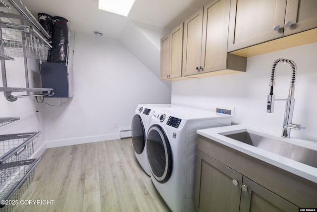 101 Jeff Davis St, Sitka, AK 99835 - washroom featuring cabinet space, washing machine and clothes dryer, light wood-style flooring, baseboards, and a baseboard radiator
