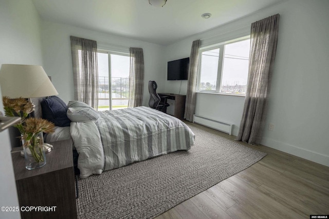 101 Jeff Davis St, Sitka, AK 99835 - bedroom with a baseboard radiator, light wood-style floors, and baseboards