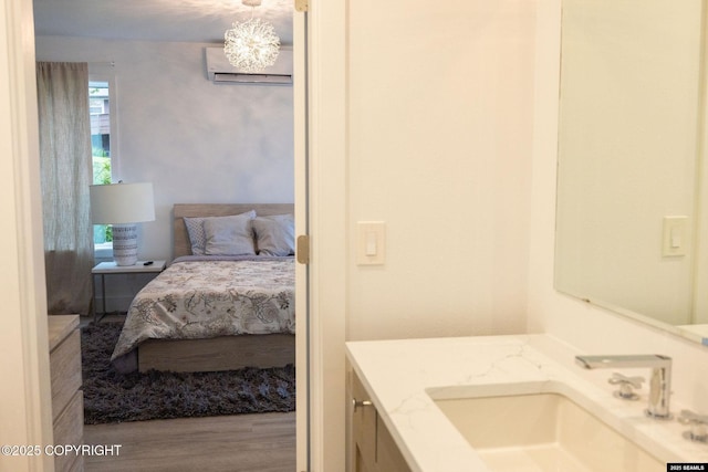 101 Jeff Davis St, Sitka, AK 99835 - ensuite bathroom with an AC wall unit, vanity, and wood finished floors