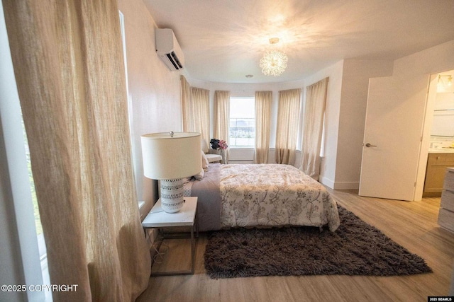 101 Jeff Davis St, Sitka, AK 99835 - bedroom with a wall mounted AC, wood finished floors, baseboards, and a chandelier