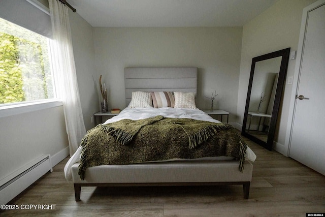 101 Jeff Davis St, Sitka, AK 99835 - bedroom featuring a baseboard heating unit and wood finished floors