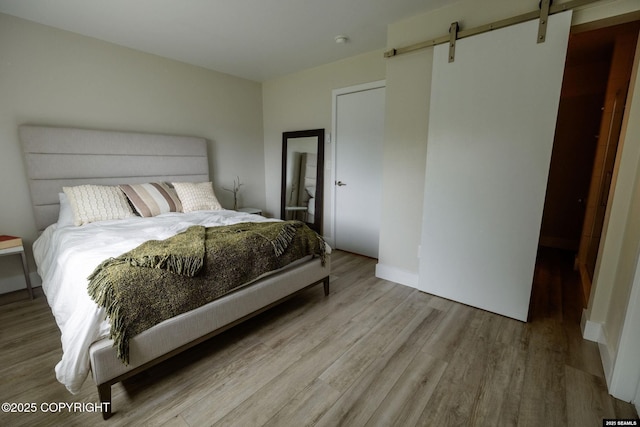 101 Jeff Davis St, Sitka, AK 99835 - bedroom with a barn door and wood finished floors