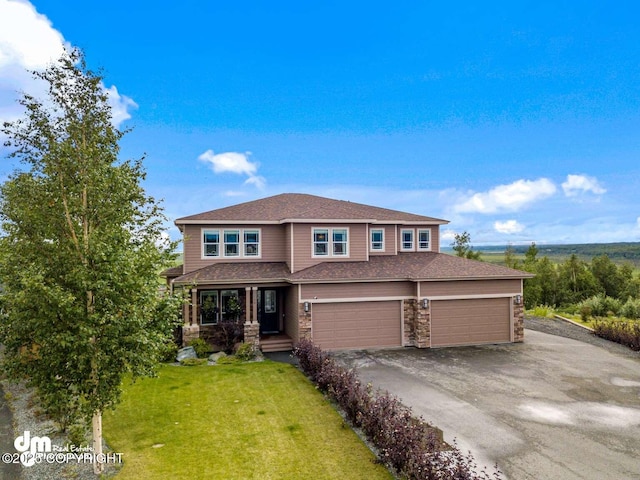 5044 E Loft Cir, Wasilla, AK 99654 - view of front of home with covered porch, a front yard, a garage, stone siding, and asphalt driveway