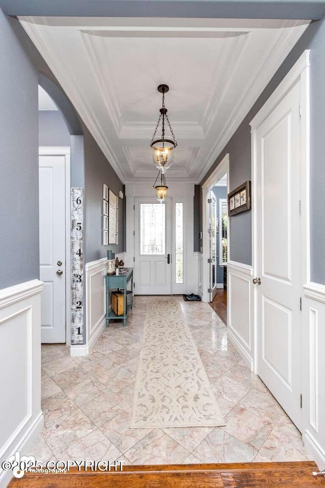 5044 E Loft Cir, Wasilla, AK 99654 - entryway with a decorative wall, ornamental molding, arched walkways, light marble finish flooring, and wainscoting