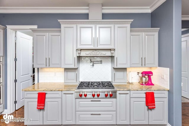 5044 E Loft Cir, Wasilla, AK 99654 - kitchen with gas stovetop, decorative backsplash, crown molding, dark wood-type flooring, and light stone countertops