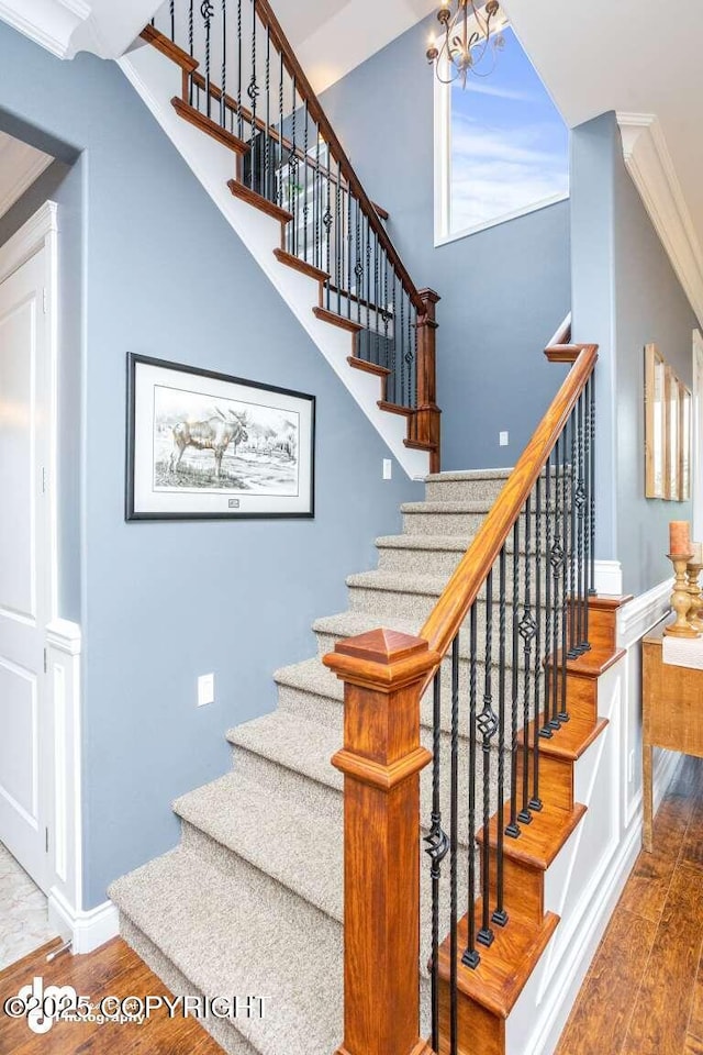 5044 E Loft Cir, Wasilla, AK 99654 - staircase with wood finished floors, a chandelier, and baseboards