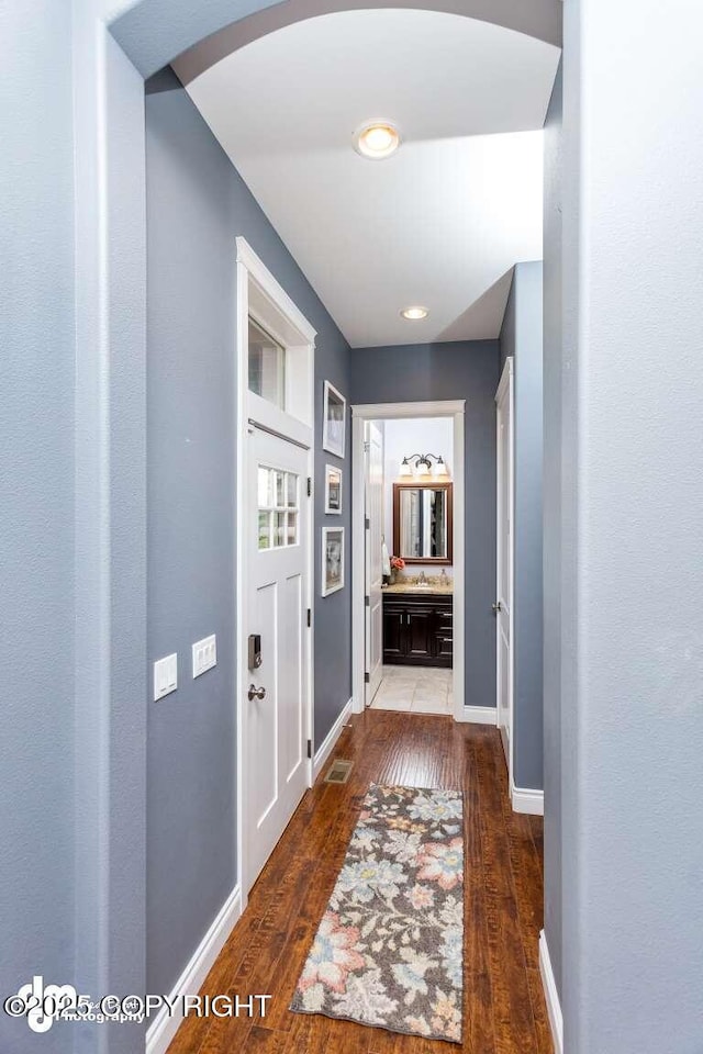 5044 E Loft Cir, Wasilla, AK 99654 - hall with arched walkways, hardwood / wood-style flooring, and baseboards