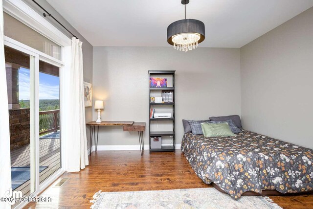 5044 E Loft Cir, Wasilla, AK 99654 - bedroom with wood finished floors, access to outside, and baseboards