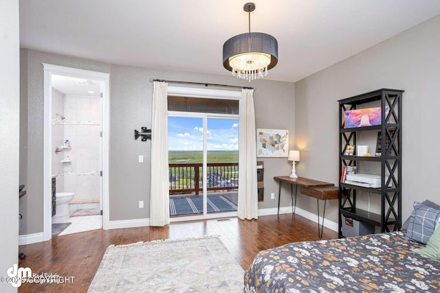 5044 E Loft Cir, Wasilla, AK 99654 - bedroom featuring access to exterior, wood finished floors, a chandelier, and baseboards