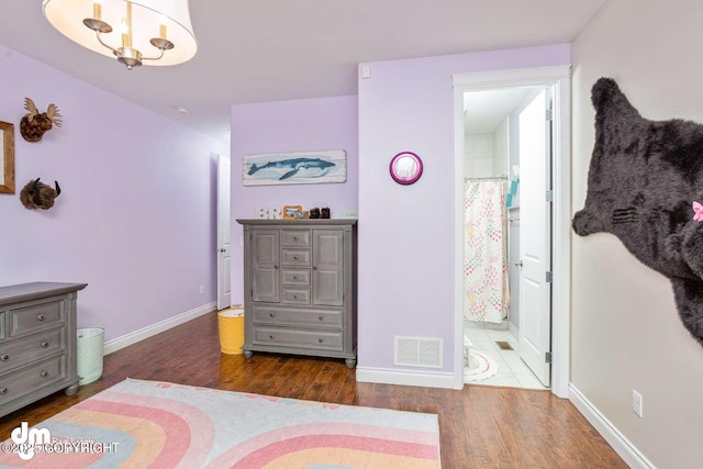5044 E Loft Cir, Wasilla, AK 99654 - bedroom with wood finished floors, baseboards, and ensuite bath