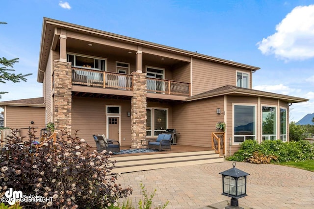 5044 E Loft Cir, Wasilla, AK 99654 - back of house featuring a balcony, a patio area, and outdoor lounge area