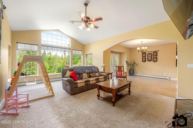 3474 E Wanamingo Dr, Wasilla, AK 99654 - carpeted living room with baseboard heating, arched walkways, ceiling fan, a chandelier, and high vaulted ceiling