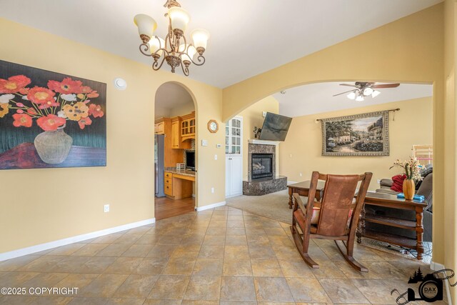3474 E Wanamingo Dr, Wasilla, AK 99654 - sitting room with a tiled fireplace, arched walkways, a ceiling fan, and a chandelier