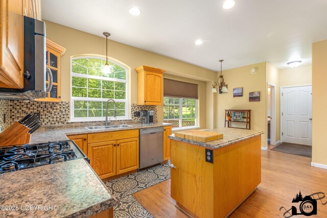 3474 E Wanamingo Dr, Wasilla, AK 99654 - kitchen featuring dishwasher, a center island, light wood-style floors, tasteful backsplash, and pendant lighting