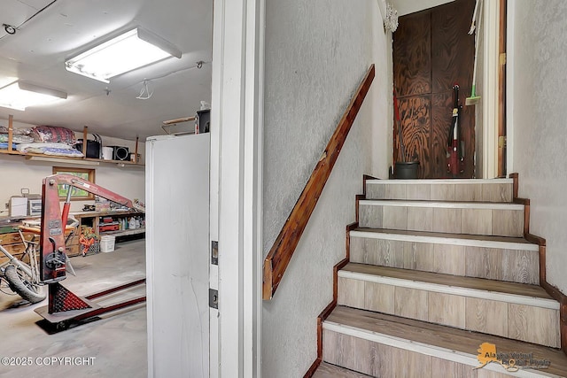 910 S Iris Cir, Palmer, AK 99645 - stairs with a textured wall and concrete floors