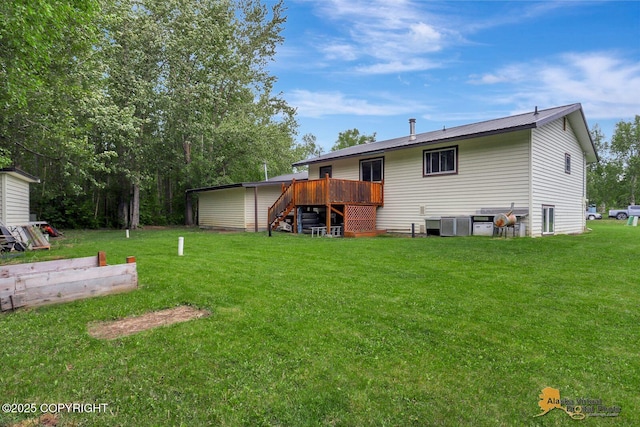 910 S Iris Cir, Palmer, AK 99645 - rear view of property with a yard, a wooden deck, and stairs