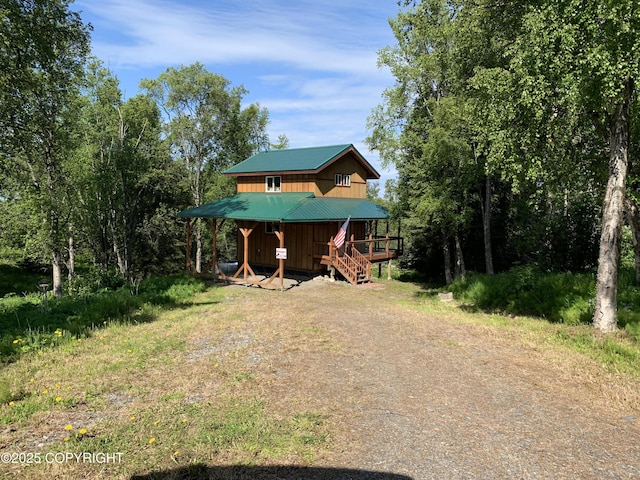 12829 Frontage Rd, Ninilchik, AK 99639 - chalet / cabin with a metal roof and stairway