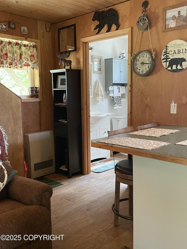 12829 Frontage Rd, Ninilchik, AK 99639 - living room with wooden ceiling, wood finished floors, heating unit, and wooden walls