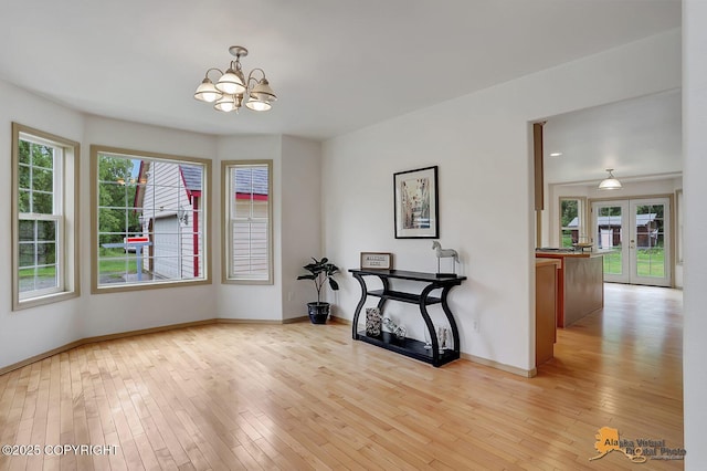 1101 E Dan St, Wasilla, AK 99654 - unfurnished dining area with a chandelier, light wood-type flooring, healthy amount of natural light, and french doors