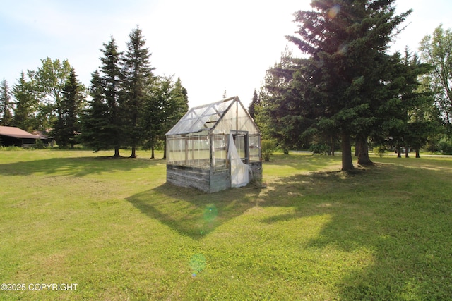 63550 Jessica G Ct, Ninilchik, AK 99639 - view of grassy yard with a greenhouse and an outdoor structure